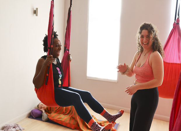 Students of the 200 hour yoga teacher training using a hammock as an equipment