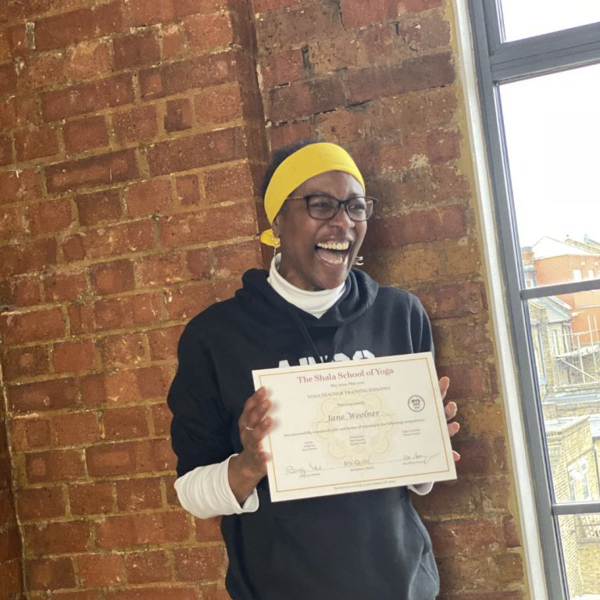 Jane W receiving her 200-hour yoga teacher training certificate