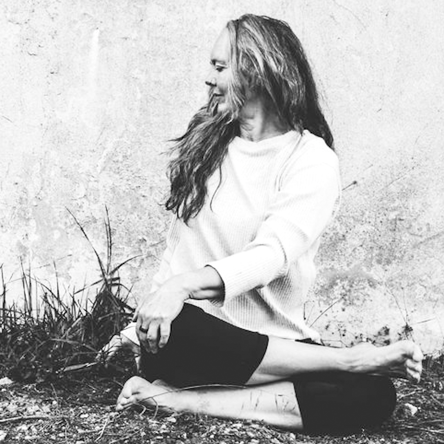 Melanie Cooper practicing a seated twist demonstrating for Yin Yoga Teacher Training