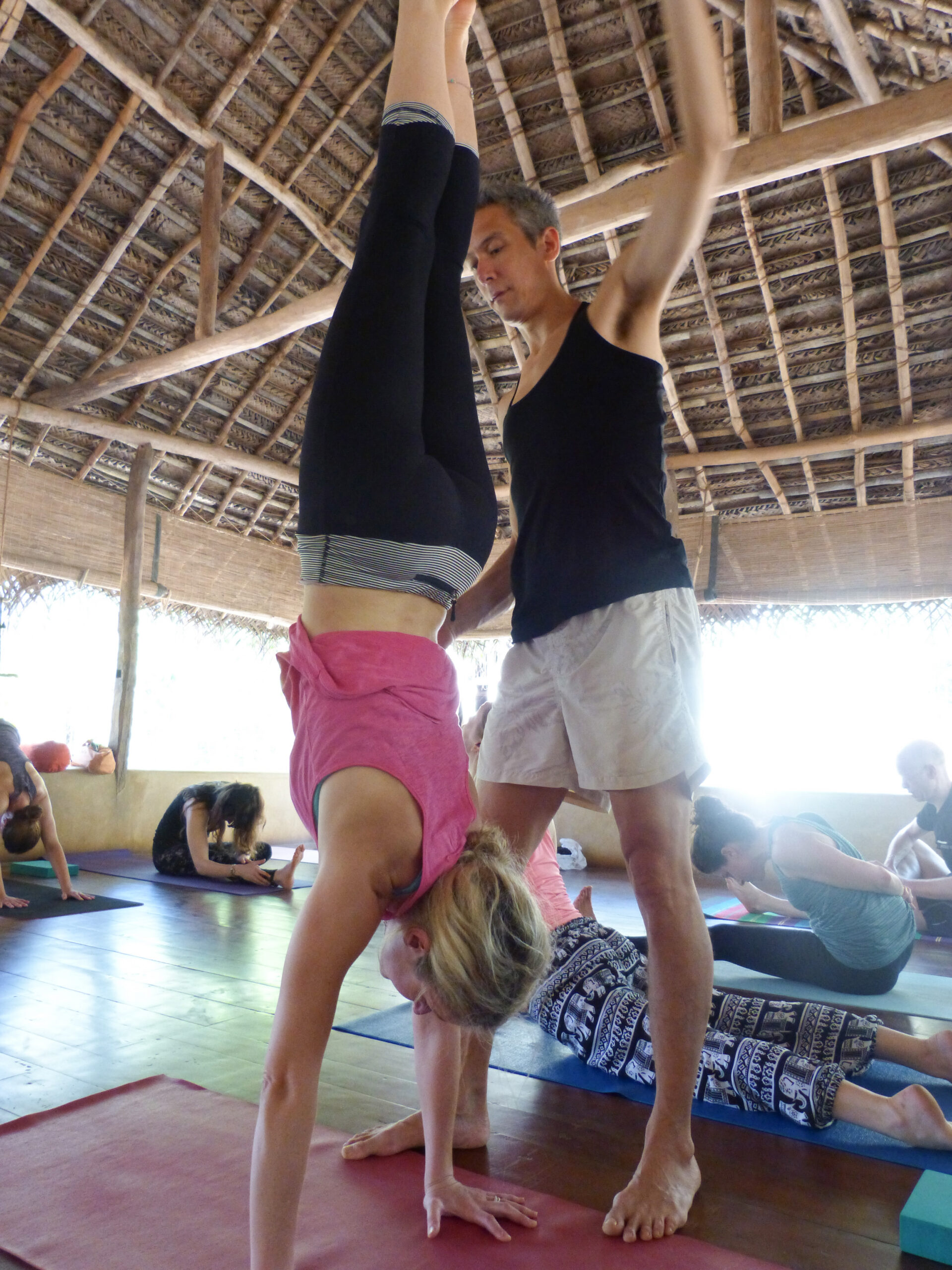 Practicing Yoga in the yoga shala at Ulpotha with Gingi Lee